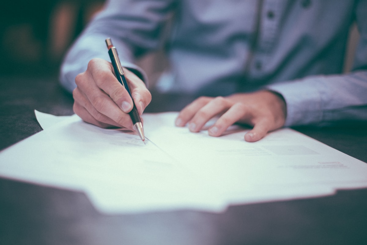 Person reviewing financial documents at a desk