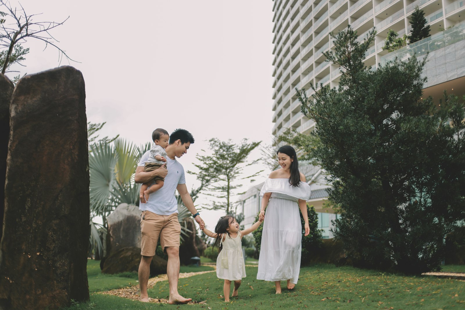 Family walking together in a grassy park